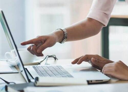Woman pointing at laptop